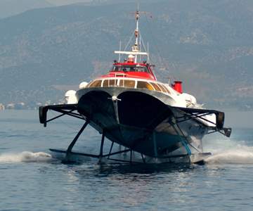 A Hydrofoil Approaching The Port Of The Greek Island Hydra